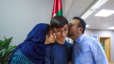 Proud mother and father, Nadir and Sameen Jafarey give their son, Zaid a kiss. Victor Besa / The National