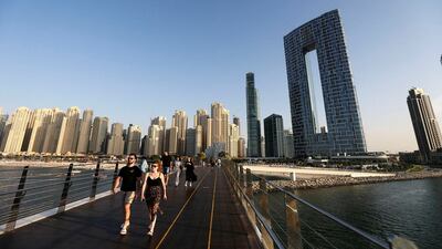 Residents take a stroll on a pedestrian bridge in the Bluewaters island development. Photo: Reuters