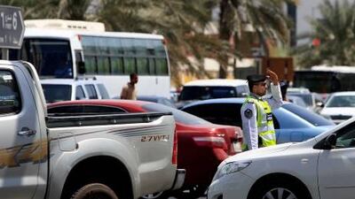 September 26, 2010 / Abu Dhabi / (Rich-Joseph Facun / The National) A police officer directs traffic at the intersection of Al Saada Street and Al Falah Street heading into the Tourist Club area, Sunday, September 26, 2010 in Abu Dhabi.