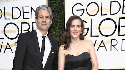 Winona Ryder, accompanied by fashion designer Scott Mackinlay Hahn, wears a custom Viktor & Rolf gown to the 74th Annual Golden Globe Awards at The Beverly Hilton Hotel on January 8, 2017. Getty