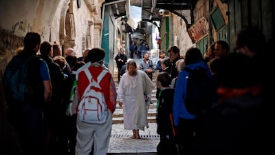 A worshipper dressed as Jesus Christ walks along the Via Dolorosa (Way of Suffering) in Jerusalem's Old City during the Good Friday procession. AFP