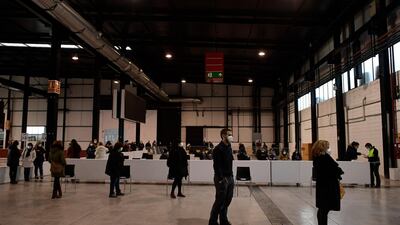 Health workers wait to be vaccinated against the coronavirus, in Pamplona, northern Spain. AP Photo