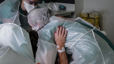 Nurses lift a Covid-19 patient at the Pasteur hospital resuscitation unit in Colmar, eastern France. AFP