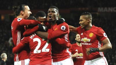 Henrikh Mkhitaryan, second left, is mobbed by teammates after scoring Manchester United's third goal. Rui Vieira / AP Photo