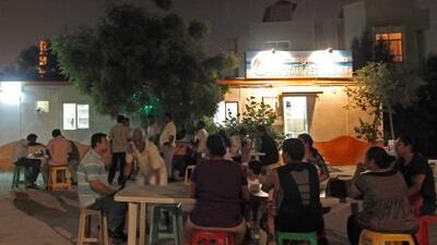 A steady queue of customers keeps the Bu Qtair restaurant busy serving fresh fish and prawns.