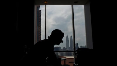 A clown is silhouetted against the backdrop of Malaysia’s iconic Twin Towers during a Clown Festival in Kuala Lumpur.