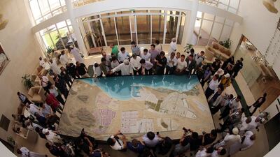 Chinese investors listening to a briefing as they check the model of the dry dock which is to be built in the Omani port city of Duqm. Mohammed Mahjoub / AFP