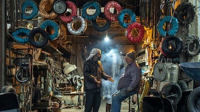 Workers at a tyre shop in Douma, on the outskirts of Damascus. Syria's economy has contracted sharply since the civil war began in 2011. AP