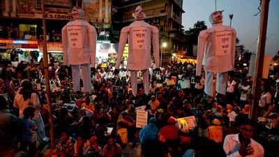 Protesters hang effigies with the signs reading, from left, "hang the guilty in the Unnao rape case", "hang the guilty in the Kathua rape case", and "hang the guilty in the Surat rape case", during a protest in Ahmedabad on April 17, 2018. Ajit Solanki / AP Photo