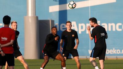 Lionel Messi, right, takes part in a training session with his Barcelona teammates. Pau Barrena / AFP