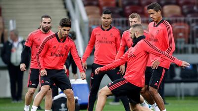 Marco Asensio, second from left, Karim Benzema, second from right, and Raphael Varane, right, attend a training session. AP Photo