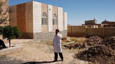 A doctor in Yemen speaks on a cell phone outside the Thula Hospital where the World Food Program has an assessment and distribution program. Ryan Carter / The National