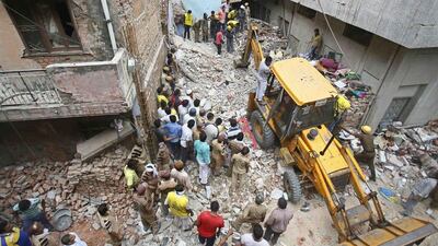 Rescuers at the site of the collapsed building. Anindito Mukherjee/Reuters