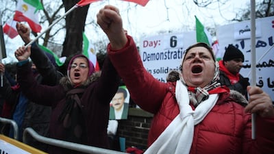 Supporters of the People's Mojahedin Organisation, Iran's main opposition, rally outside the Iranian regime's embassy in London, in solidarity with Iranian people's protests nationwide. Victoria Jones / AP