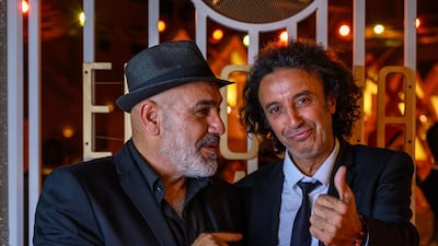 Directors Rashid Masharawi and Ismael Ferrouki pose on the red carpet during the closing ceremony of the El Gouna Film Festival. AFP