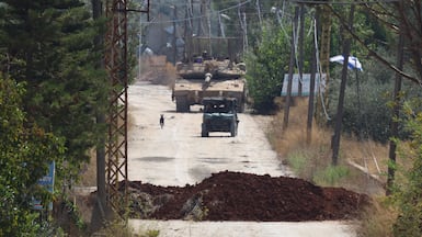 Israeli military Merkava main battle tanks are seen along the western entrance to the town of Khiam, southern Lebanon, on Tuesday. AFP
