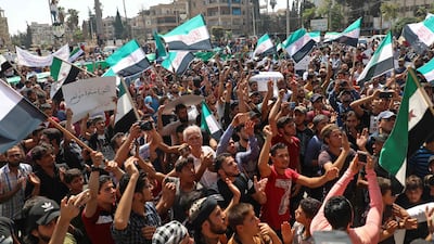 People in Idlib protest against Bashar Al Assad, whose regime has been propped up by Tehran by extending credit lines amounting to tens of billions of dollars. AFP