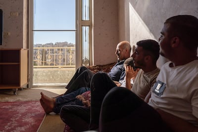 From left, Mohammed Tal with his son Ali, nephew Mohammed and son Riziq in the family’s new home, after being displaced from Zanuta. David Lombeida for The National