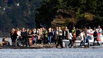 Survivors of the Utoeya shooting massacre arrive to board boats to go to Utoeya island, 40 km (25 miles) northwest of Oslo August 20, 2011. Some 1,000 people are expected to visit the island on Saturday when survivors and their relatives go back ahead of ???
