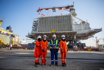 Petrofac grads and country chair on site. Photo: Petrofac