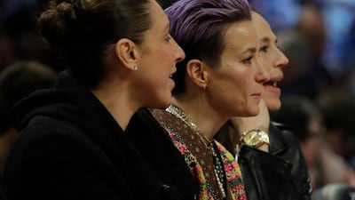 US Women's soccer players Diana Taurasi, Megan Papinoe and Sue Bird watch the action. AP