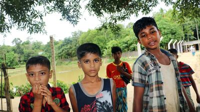 Rohingya refugee children pose for pictures on a road along the makeshift camp in Ukhia, Cox's Bazar district, Bangladesh. EPA