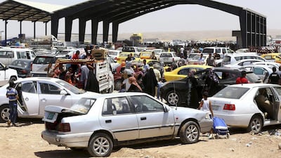Thousands of families fleeing from Mosul, one of the great historic cities of the Middle East, arrive at a checkpoint in outskirts of Arbil on June 10, 2014. Reuters