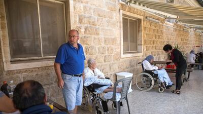 Palestinians with their hospitalised family members from the palliative department on a terrace of the Augusta Victoria Hospital.