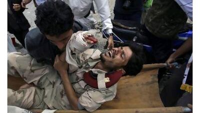 Anti-government demonstrators carry a wounded defected soldier from the site of clashes with security forces to a field hospital in Sanaa, Yemen, yesterday. Hani Mohammed / AP Photo