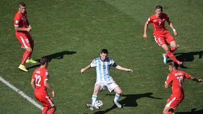 Argentina forward and captain Lionel Messi, centre, controls the ball as he is surrounded by Switzerland defender Fabian Schar, bottom left, midfielder Granit Xhaka, top left, defender Stephan Lichtsteiner, top right, and defender Ricardo Rodriguez, bottom right, during their round of 16 match on Tuesday at the 2014 World Cup. Gabriel Bouys / AFP