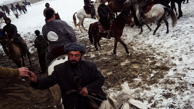 A spectator gives a rider a few hundred Afghani for scoring. While some riders have corporate sponsorships the majority are solely paid through earnings per goal.