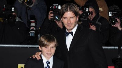 David Beckham, in a formal coat and classic tux, and son Brooklyn attend The Sun Military Awards at the Imperial War Museum in London, England, on December 15, 2010. Getty Images
