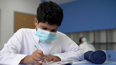 A Saudi schoolboy wearing a face mask in a classroom in Riyadh. Reuters