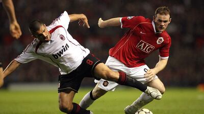 United forward Wayne Rooney is tackled by AC Milan's Gennaro Gattuso. AFP