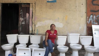 A woman selling toilet products poses for a photo at the Oriental Market in Managua, Nicaragua. Oswaldo Rivas / Reuters