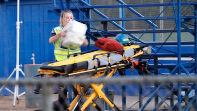 Paramedics prepare a gurney at Gilroy High School. At least 15 people were wounded in the shooting.
