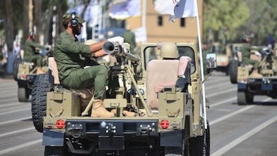 Members of Iraq's Popular Mobilisation Forces take part in a parade to mark the seventh anniversary of the organisation's founding at Camp Ashraf in Diyala province. AFP