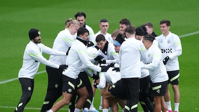 Manchester City's Nathan Ake is surrounded by his teammates during a training session at the City Football Academy. PA