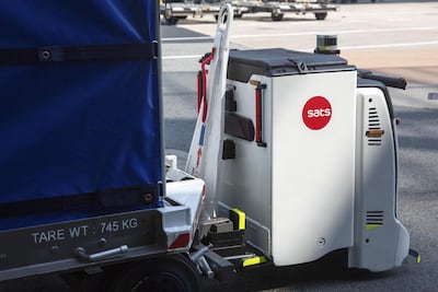 An Autonomous Container Trailer transports a cargo container to the baggage holding area. Bloomberg