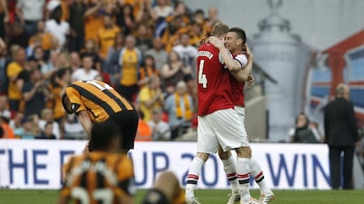 Arsenal defenders Per Mertesacker and Laurent Koscielny, right, celebrate after winning the FA Cup final over Hull City on Saturday. Adrian Dennis / AFP / May 17, 2014