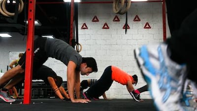 A class does a super worm walk at one of Candice Howe’s CrossFit sessions in Dubai. Lee Hoagland / The National