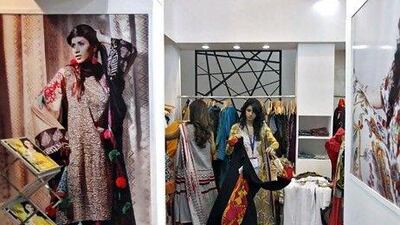 Exhibitors from Pakistan prepare their stall of clothing at the Lifestyle Pakistan Exhibition in New Delhi last week. REUTERS/Adnan Abidi