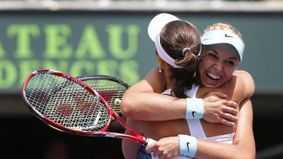 Sabine Lisicki, right, of Germany hugs Martina Hingis of Switzerland after they win the women's doubles final match against Ekaterina Makarova and Elena Vesnina of Russia at the Miami Masters tennis tournament on Key Biscayne in Miami, Florida, USA, on Sunday. Erik S Lesser / EPA / March 30, 2014