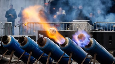 Local residents watch the annual carbide shooting, firing footballs from milk churns turned into cannon, during New Year's Eve celebrations in Ommen, the Netherlands. EPA