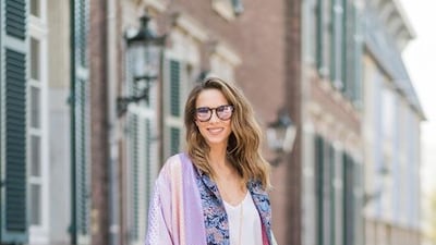 Model and fashion blogger Alexandra Lapp wearing a printed kimono / panel robe from Natasha Zinko, slim fit high waist Jeans from Rag & Bone, Mules by Gucci with open-toe-silhouette in glittery silver grey, white silk tank top from Jadicted, colourful mirrored sunglasses from Les Specs, black leather ring detail continental purse bag from Fendi. Christian Vierig / Getty Images