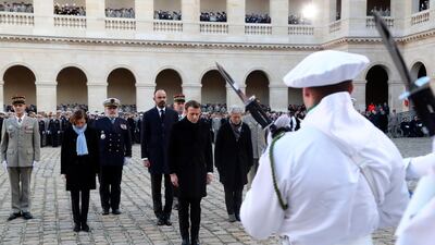 French President Emmanuel Macron with French defence minister Florence Parly review the troops during the national ceremony. EPA