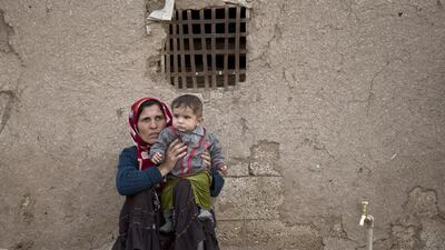 Syrian Kurdish refugees from Kobani sit in the village of Alanyurt on the Turkish side of the Turkey-Syria border on October 27, 2014. Vadim Ghirda/AP Photo
