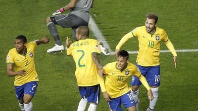 Brazil’s midfielder Douglas Costa, left, celebrates with teammates Dani Alves, second from left, Neymar, second from right and Everton Ribeiro after scoring against Peru during their 2015 Copa America football championship match in Temuco, Chile, on June 14, 2015. Brazil won 2-1. AFP PHOTO / CLAUDIO REYES