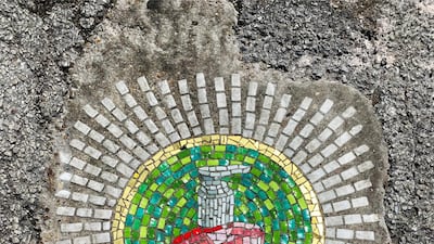 The potholes have been filled with pandemic-inspired mosaics. Reuters