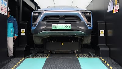 A Nio ES8 electric SUV has its battery changed inside a power station at a JAC Motors plant in Hefei, China. Reuters
